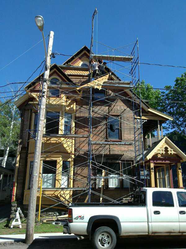 Three storey house under renovation with scaffolding