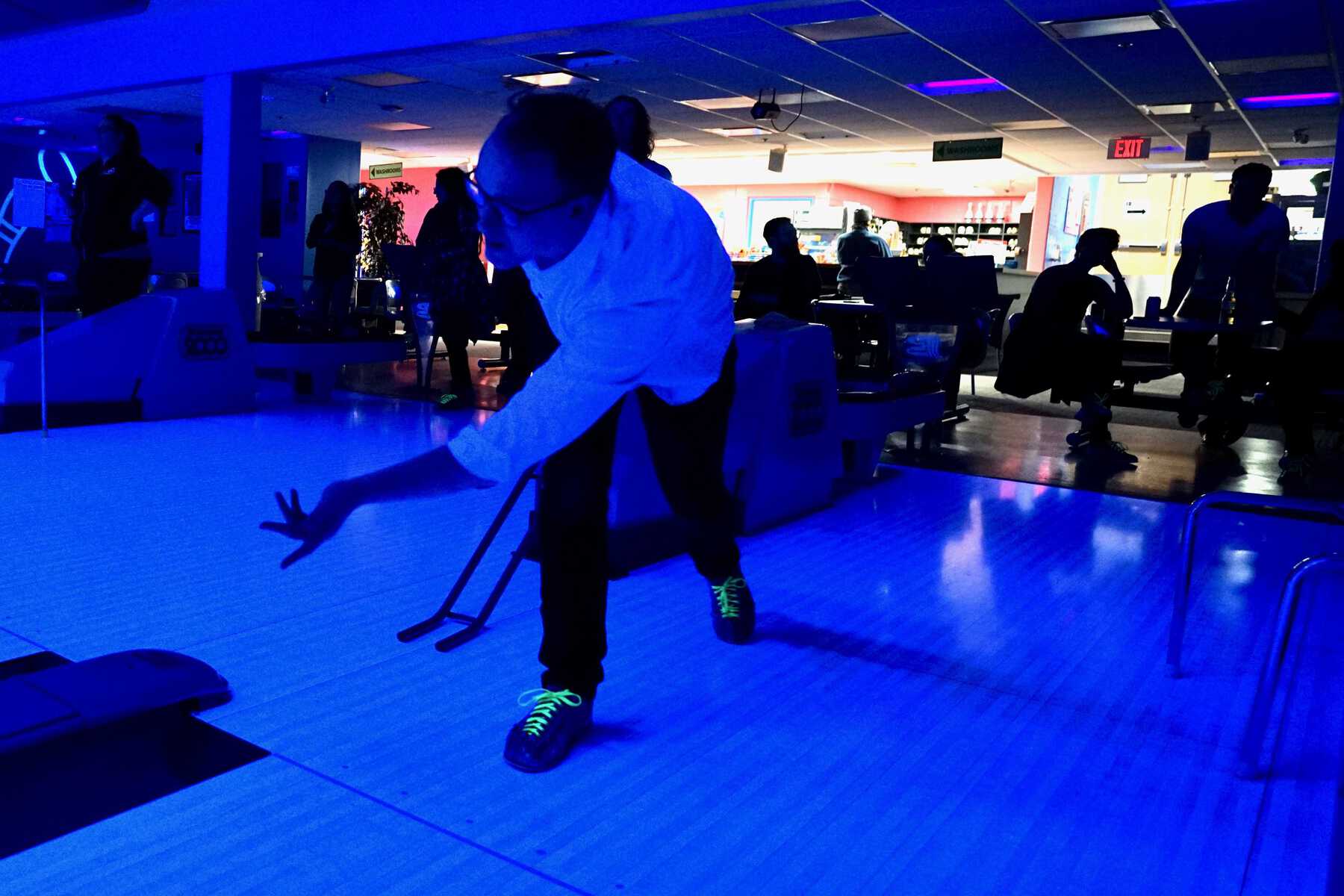 Man in neon light bowling