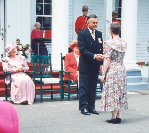 Woman in dress shaking hands with man in suit
