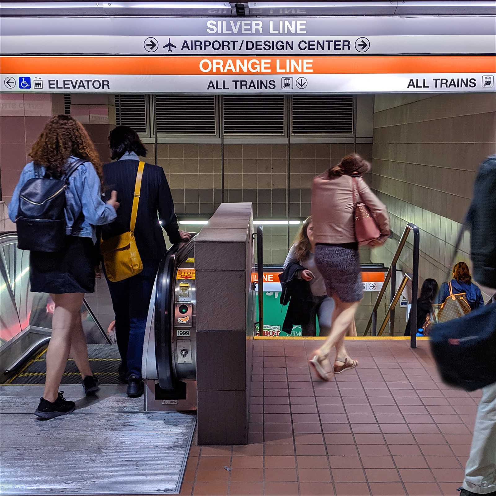 Digitally altered photo of subway station with signs reading 'silver line' and 'orange line'