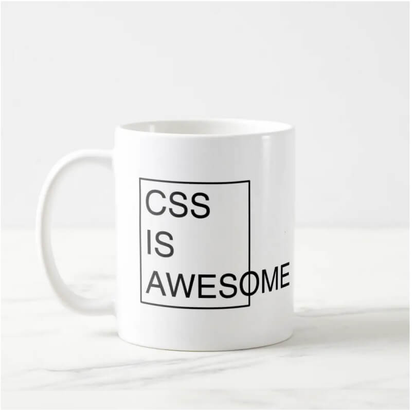 White mug with design of black bordered square containing black uppercase text: 'CSS is awesome'. This text overflows the square.