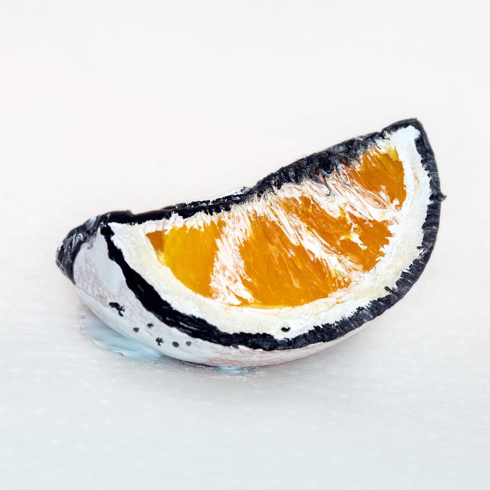 Orange fruit slice painted to look like silverorange logo