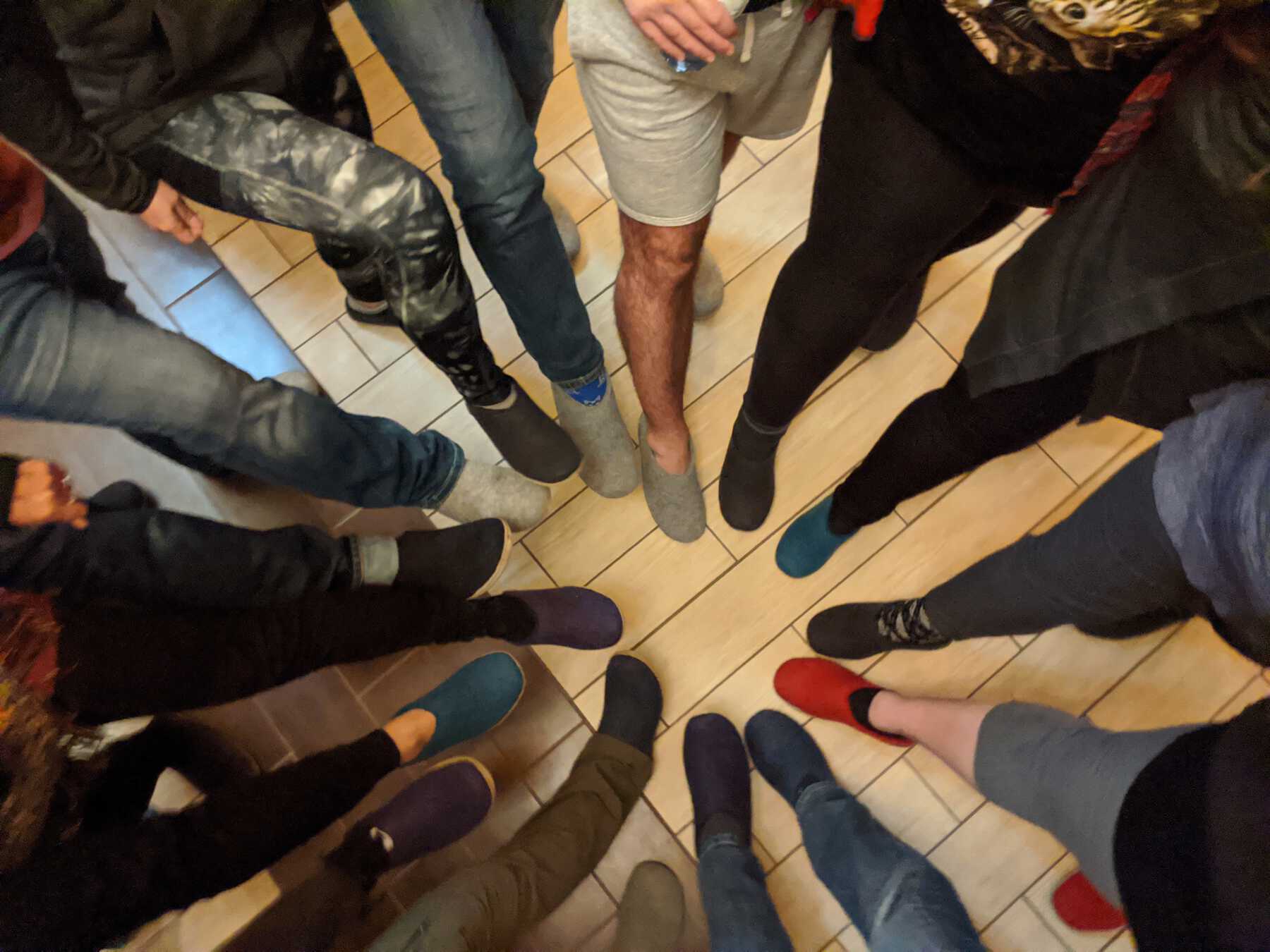 Circle of people's feet wearing slippers